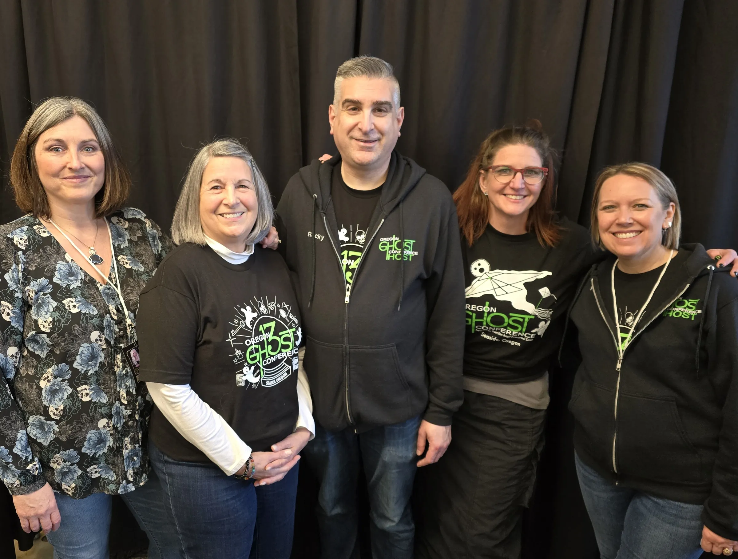 Five of the conference crew smiling together in Oregon Ghost Conference shirts