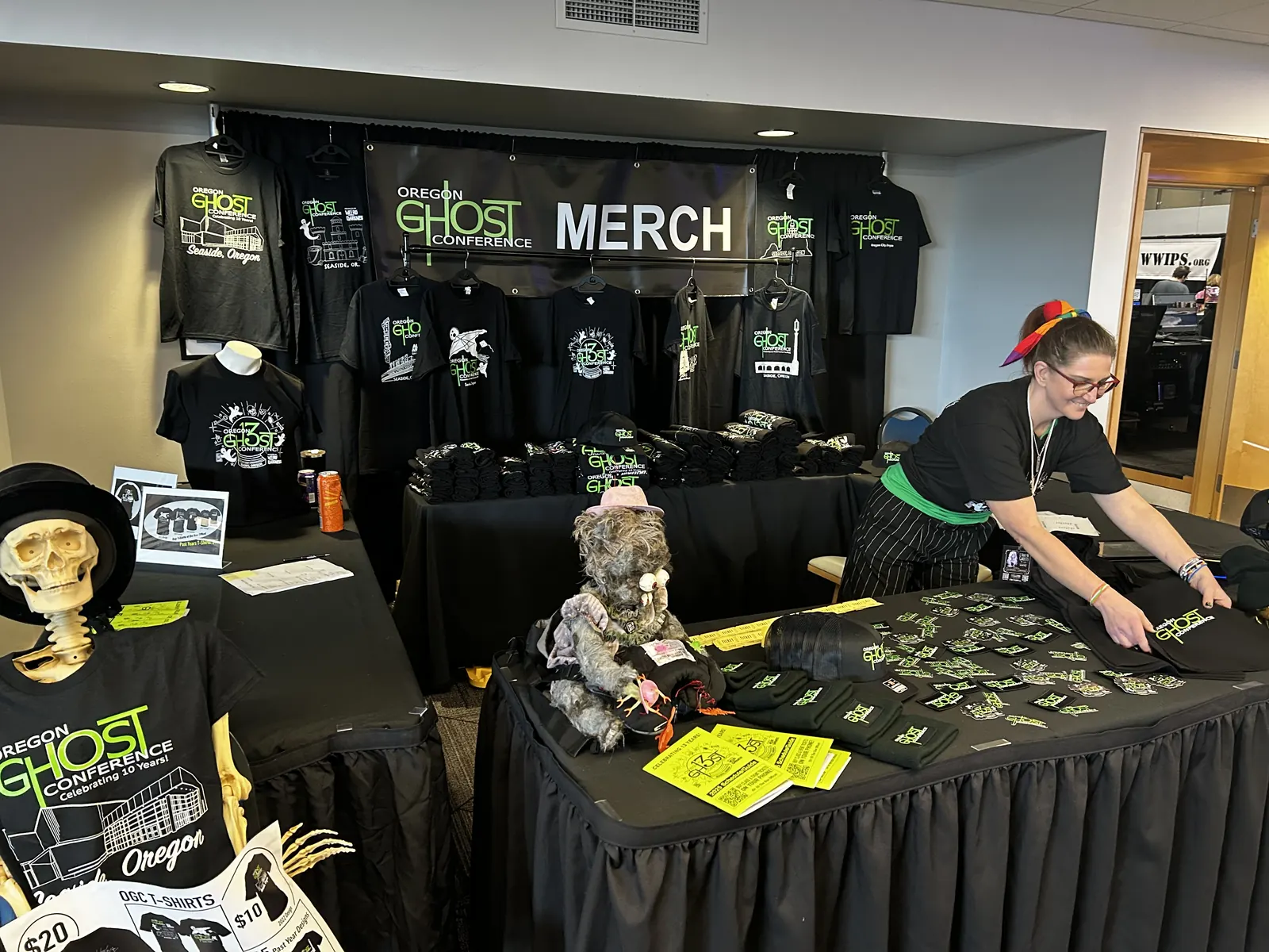 The merch room, staffed by a skeleton in a top hat
